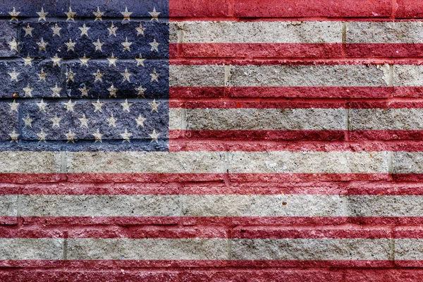 American flag painted on a gray stone bricks wall