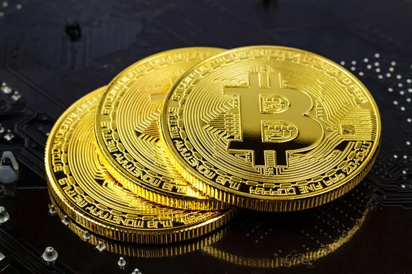 Золотые биткоины на черном фоне крупным планом. Виртуальные деньги в криптовалюте — стоковое фото