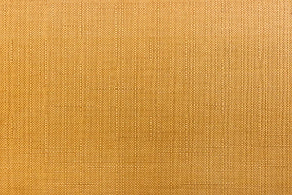 Abstract texture of orange cotton fabric with vertical and horizontal lines. Natural fabric background