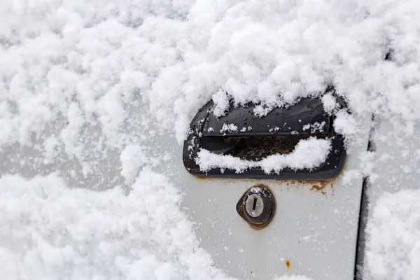 Nieve cubierta de la manija de la puerta del coche primer plano. Coches en invierno — Foto de Stock