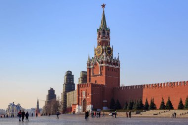 Moskova, Rusya - 15 Nisan 2018: Yürüyen turist kırmızı kare bir güneşli sabah Moskova Kremlin ve işçinin kule arka plan üzerinde