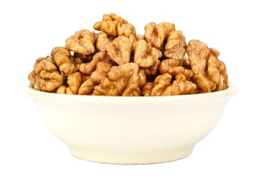 Peeled walnuts in the small ceramic bowl isolated on white background