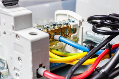 Fragment of assembled electrical panel with colored wires close-up
