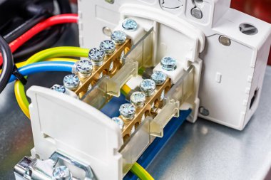 Close-up view of installed in electrical panel and connected wire terminal with open protective cover