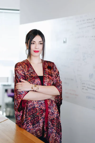 Portrait of beautiful and confident businesswoman standing in new office. 图库照片