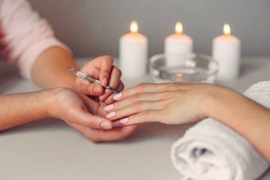 Bakım tırnak. Güzel kadın closeup spa salonda Başlarken manikür eller. Kadın manikürcü kütikül profesyonel manikür itici aracı ile temizlik. Kozmetik prosedür.