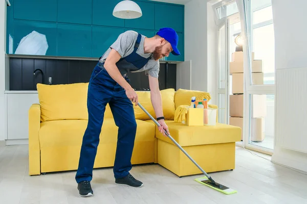 Young professional cleaner washing the floor. Janitor cart. — Stock Photo, Image