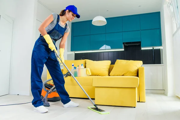 Cleaning concept. Young woman washing floor on the kitchen — Stock Photo, Image