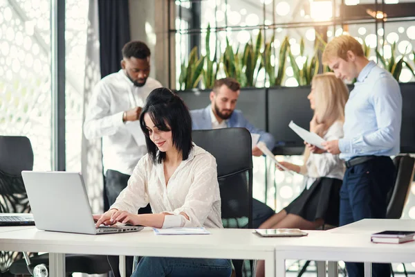 Attractive experienced business woman works at the computer in modern office. Successful business lady concept.