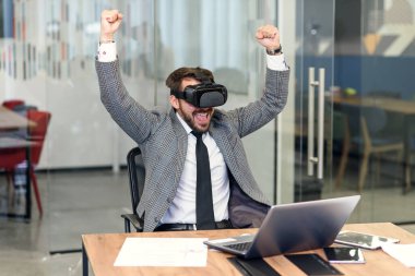 Ofiste çalışan genç insanlar, yaratıcı sakallı adam yeni bir ürün deniyor ya da sanal gerçeklik gözlükleriyle oyun oynuyorlar.