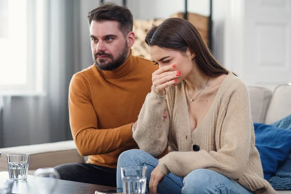 Young loving wife supporting her depressed husband during psychotherapy session with counselor, free space — Stock Photo, Image