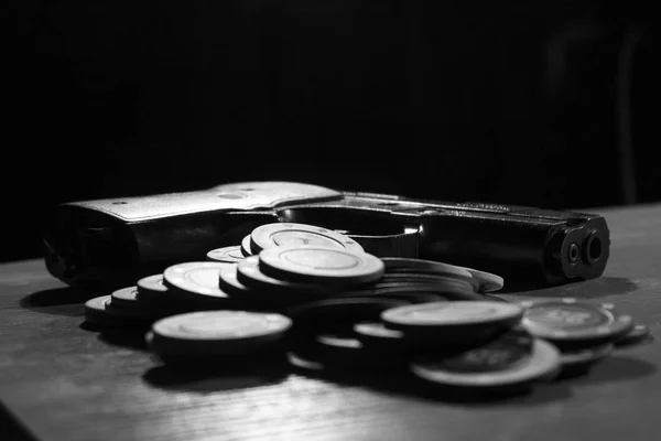 Пістолети та покерні чіпси чорно -білого на столі ліцензовані запасні зображення