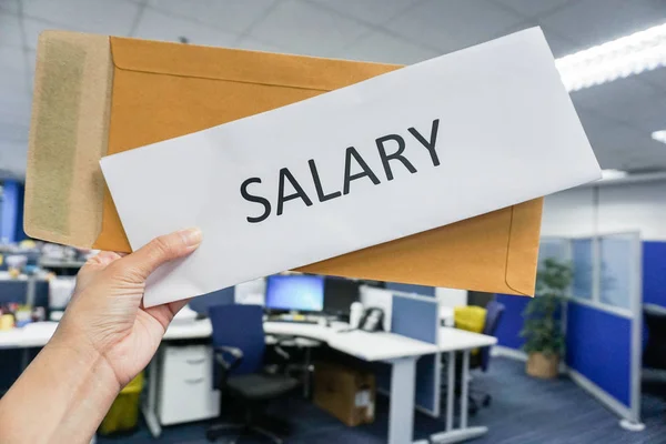 woman hold icon of salary in hand with office background