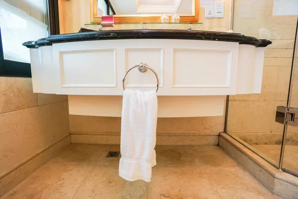 Белое полотенце на перилах в умывальнике в ванной комнате отеля — стоковое фото