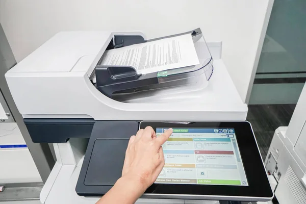 woman start document scanning by office printer