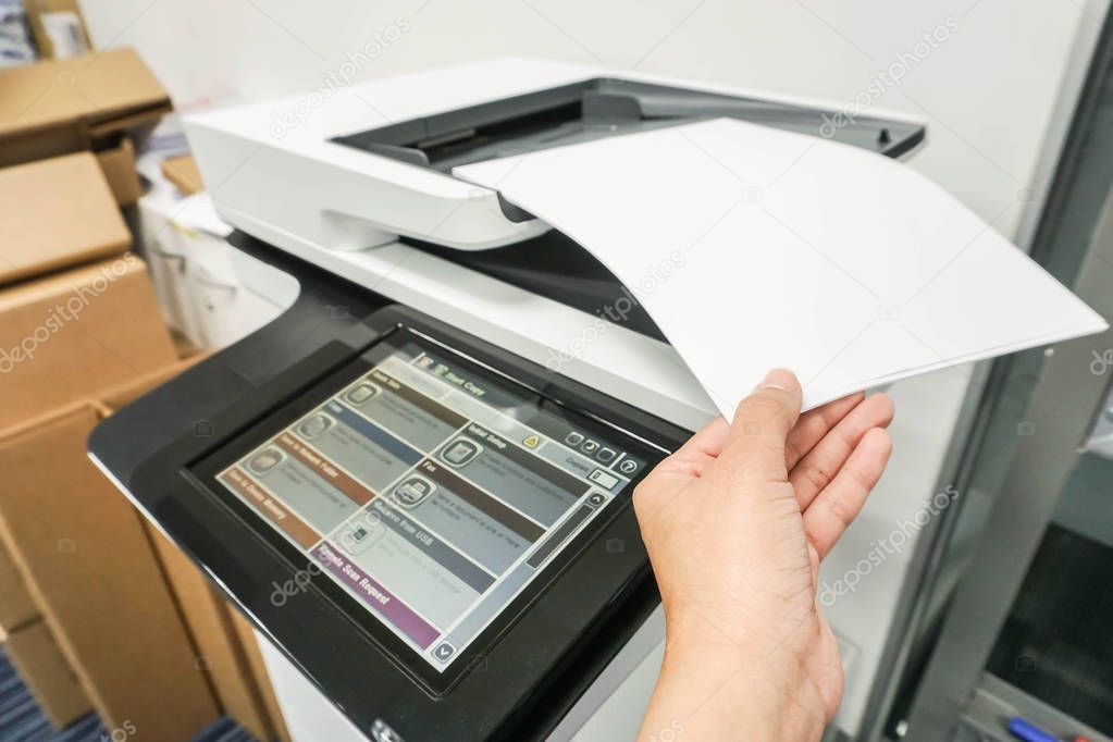 close up pull mock up business documents from office printer