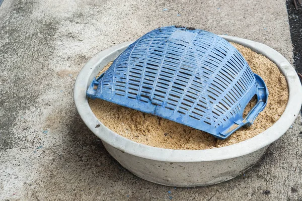 hod and sand in stainless bucket