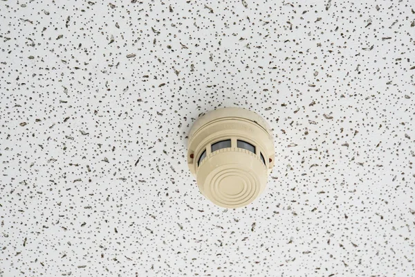 smoke alarm detector on the ceiling for building safety
