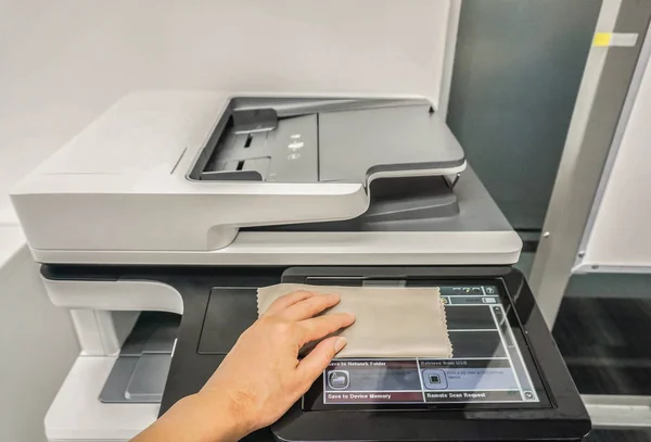 close up people clean touch screen of office printer for mainten