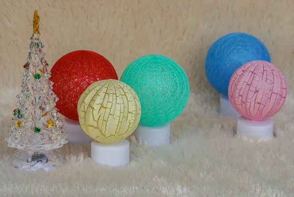 season greeting concept - glow yarn ball lighting lamps with cute Christmas tree for home decoration
