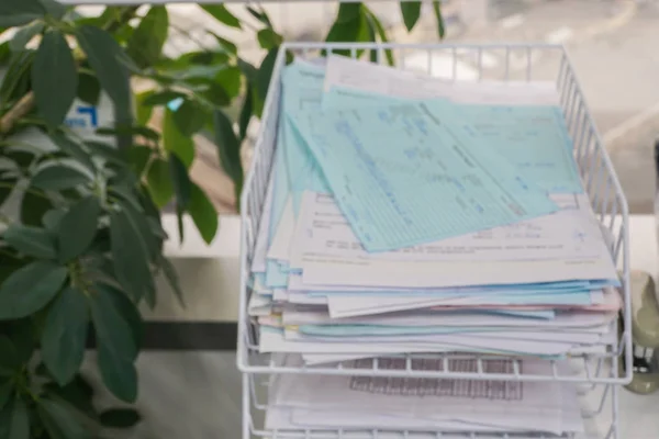 defocused and blurred finance and business documents on office tray