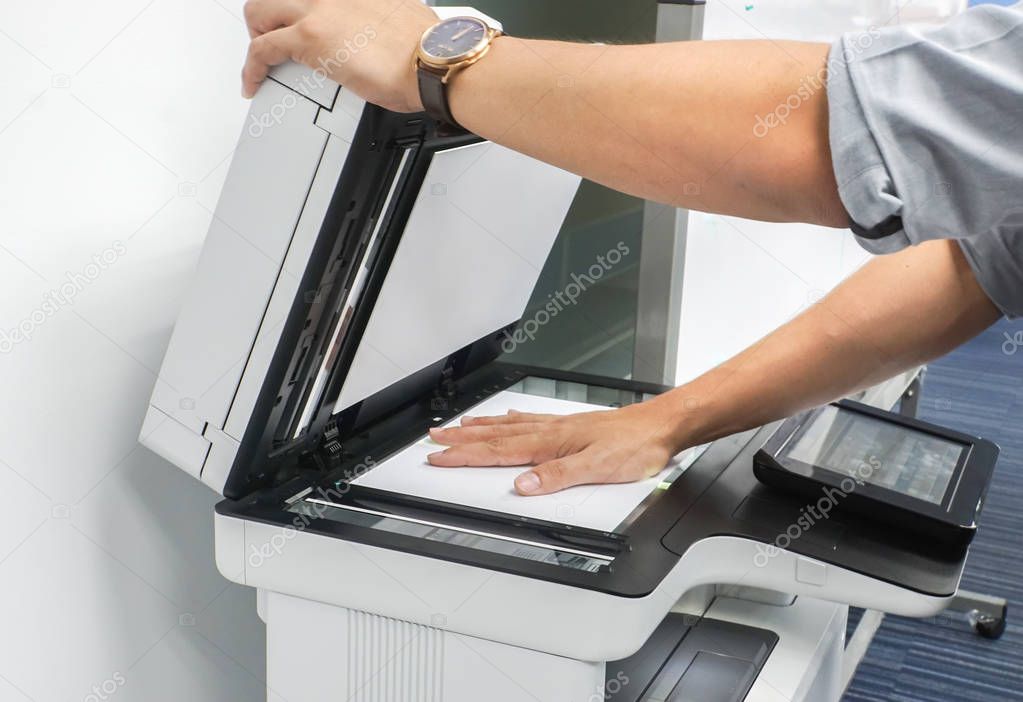 close up businessman use printer glass plate to scan important and confidential documents in office