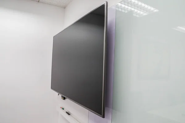 close up LED big Internet television screen with whiteboard in boardroom