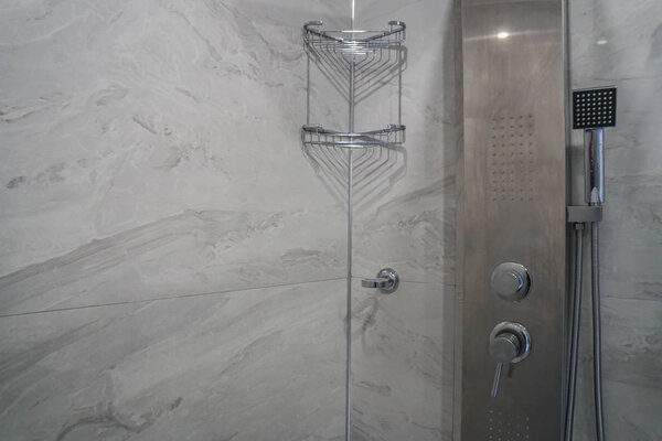 modern shower tank with soap rack in hotel bathroom
