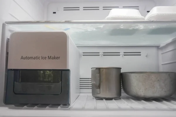 automatic ice maker function in modern refrigerator in freezer