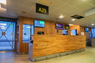 Oslo Gardermoen Airport / Norway - December 25 2019: wooden counter for gate A25 for passenger departure flight