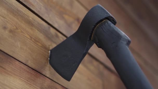 The ax is driven into a wooden wall — Stock Video