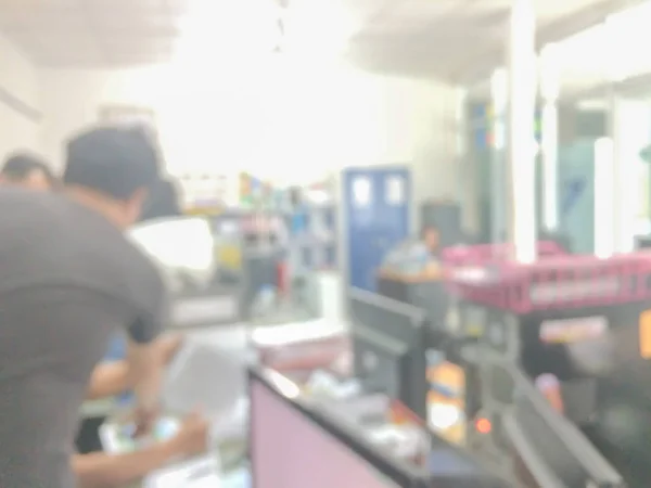 Blurred image of counter service at hotel for background usage.Blur abstract background hall customer or cashier desk indoor space in office bank interior:staff working.lab