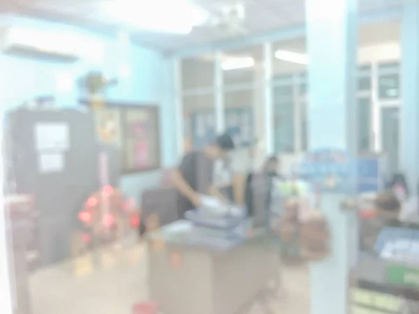 Blurred image of counter service at hotel for background usage.Blur abstract background hall customer or cashier desk indoor space in office bank interior:staff working.lab
