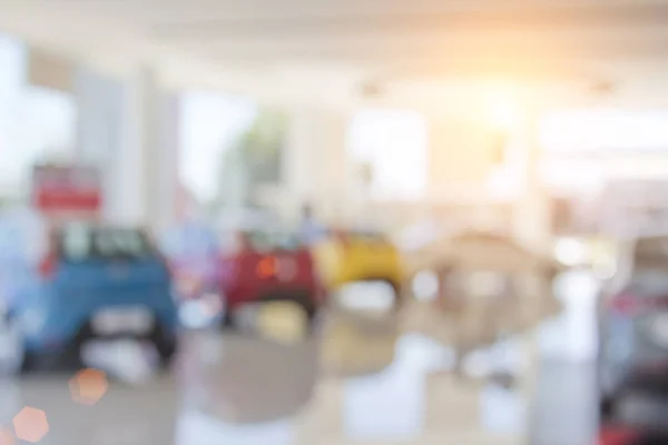 Background blur of car and showroom.Businessmen blur in the workplace.abstract blur background  work in office with car.Abstract background of office. shallow depth of focus.auto motor sale shop color