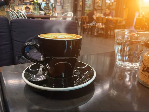 Hot milk latte art coffee on wooden table .Mock up Blank screen