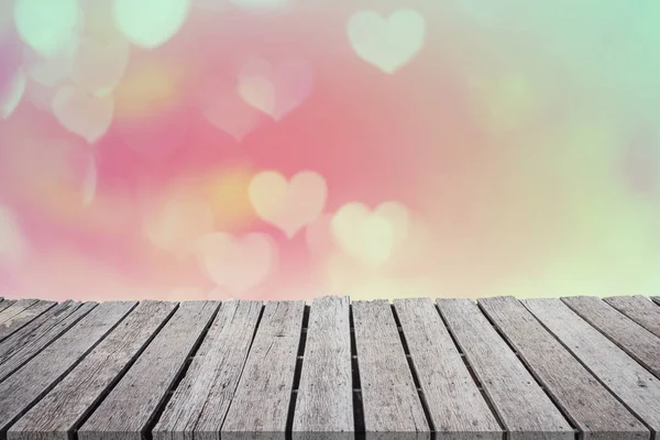 Pink heart bokeh on wooden balcony blurred background of Valentine\'s day concept. Valentines Day Card. Pastel color tones. Multicolored white hearts wallpaper.