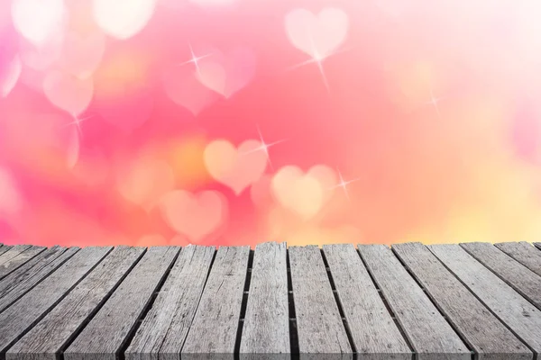 Pink heart bokeh on wooden balcony blurred background of Valentine's day concept. Valentines Day Card. Pastel color tones. Multicolored white hearts wallpaper.