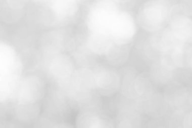 Soyut beyaz bokeh, arka planda bulanıklık olan, klasik tarzda bulanık ışık partisi, sıcak ışıltı ve soluk renkli, dairesel, sönük modern. Tatil için gri, parlak fotokopi alanı.