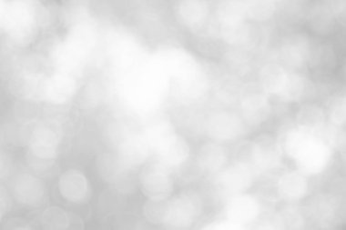 Soyut beyaz bokeh, arka planda bulanıklık olan, klasik tarzda bulanık ışık partisi, sıcak ışıltı ve soluk renkli, dairesel, sönük modern. Tatil için gri, parlak fotokopi alanı.
