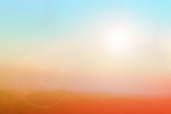 Natural background blurring warm colors and bright sunlight. Bokeh or Christmas background blue sun at sky sunny color orange light patterns plain abstract flare evening clouds blur. Heavenly mind view at a resort deck touching
