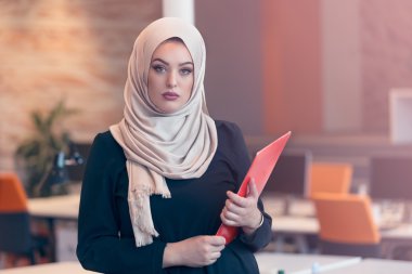 Arabian businesswoman holding a folder  clipart