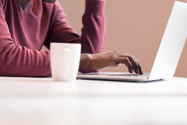 Hands typing on laptop