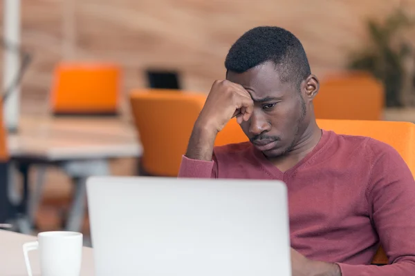 Handsome African American man looking at screen — Φωτογραφία Αρχείου