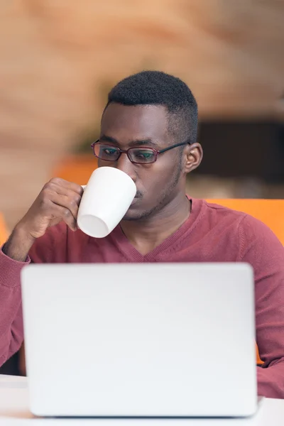 African businessman typing looking on laptop. — ストック写真