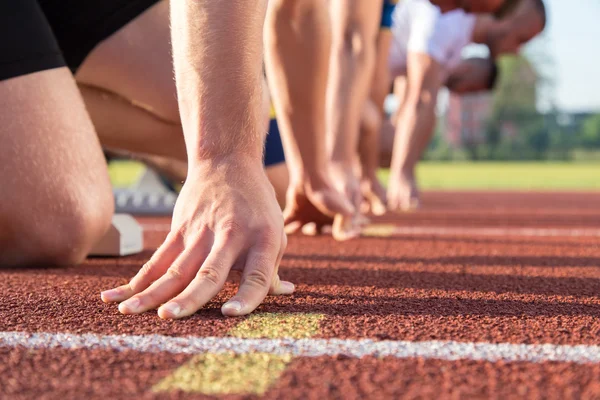 Male athletes at starting line — Stock Photo, Image
