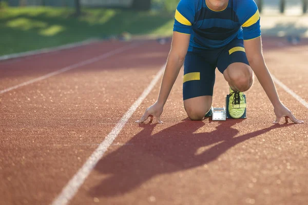 Track runner in starting position