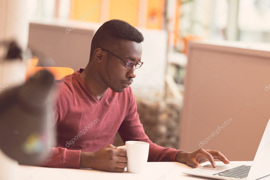 Handsome African American man looking at screen 