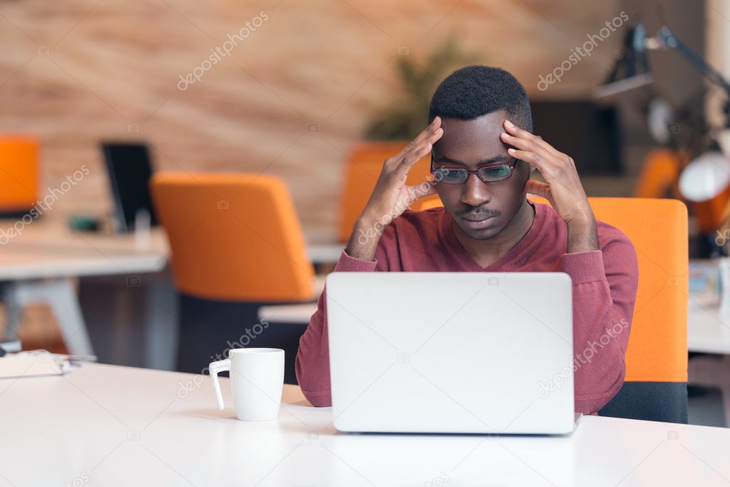 Handsome African American man looking at screen 