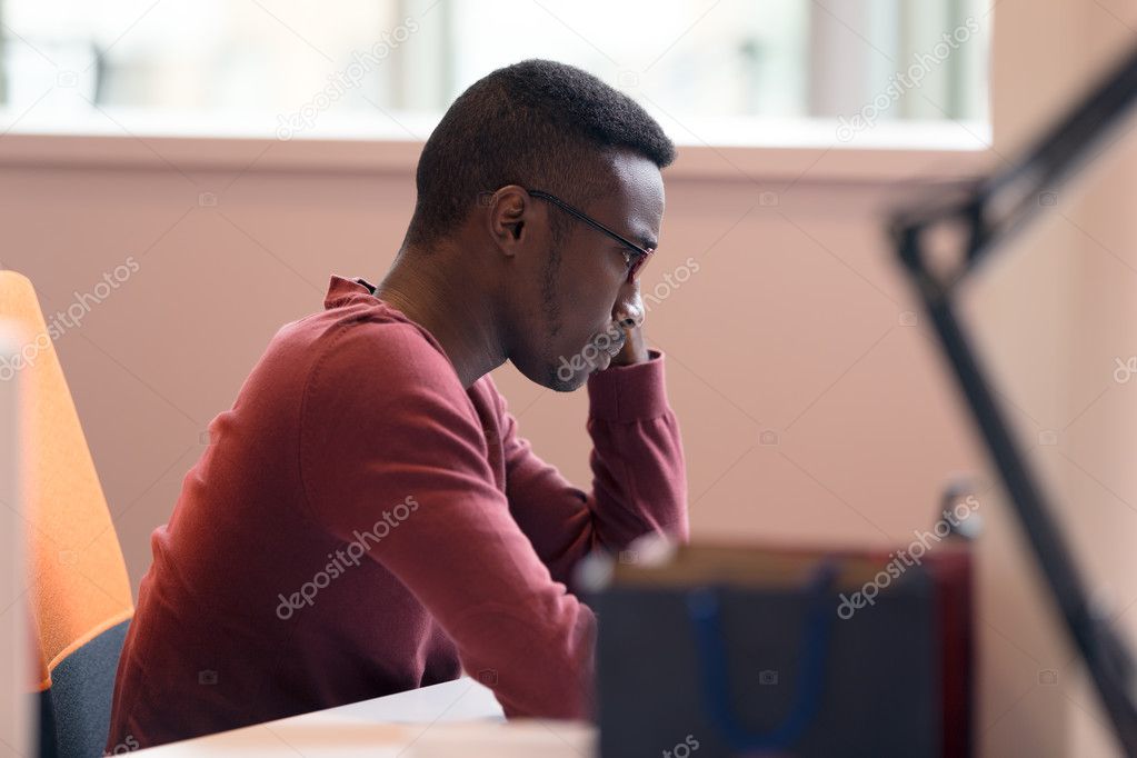 Handsome African American man looking at screen 