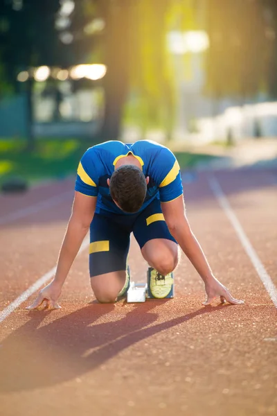 Uomo atletico in pista che inizia a correre . — Foto Stock